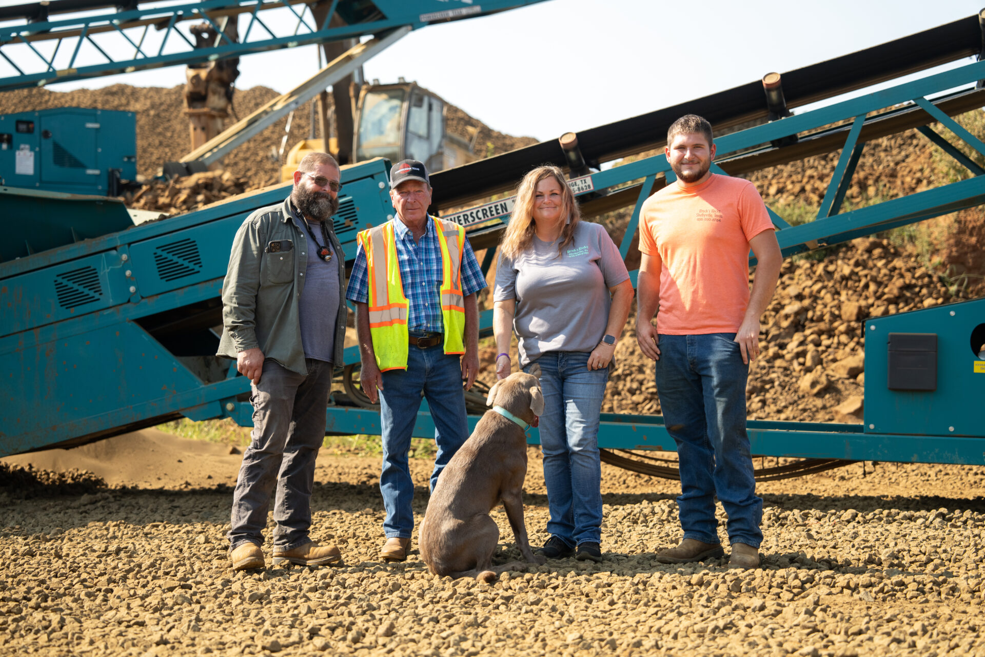 people standing on a jobsite in front of working conveyors