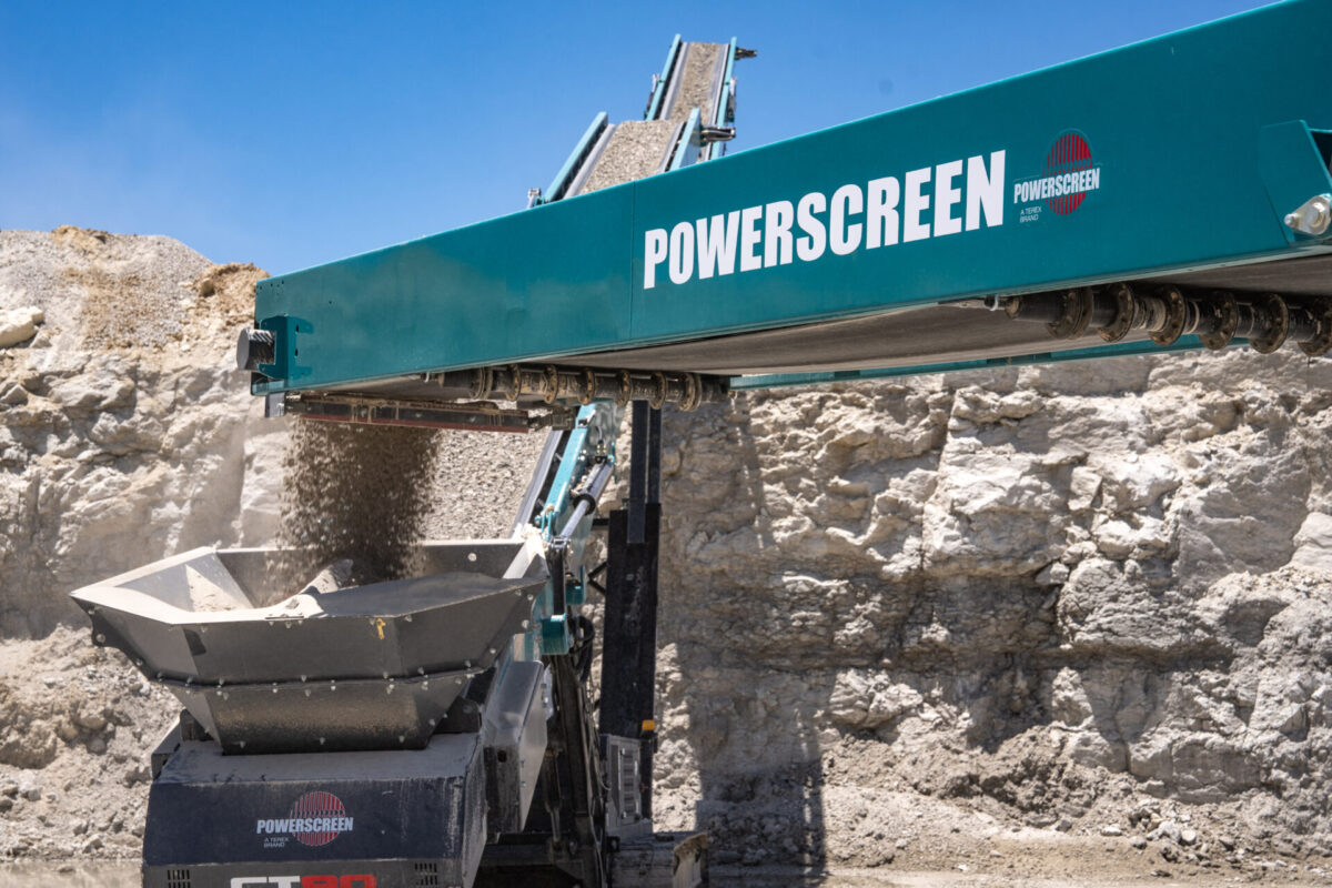 CT80 stacker carrying crushed rocks and dumping it for processing.