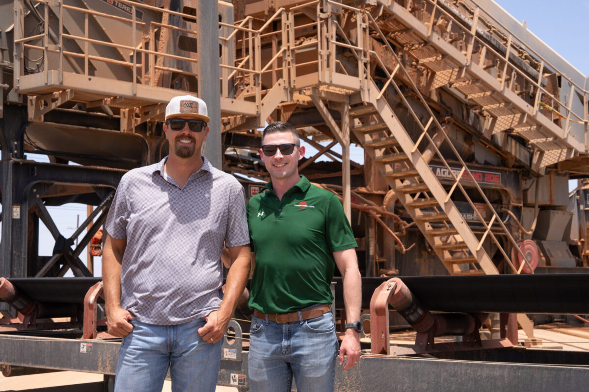 2 men standing in front of Aggresand 206
